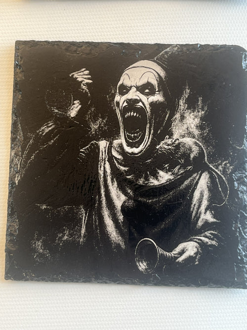A square black slate art plaque featuring a high-contrast, white-carved horror illustration of a screaming clown.