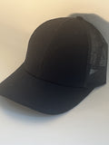 A black trucker-style baseball cap with a solid black front panel and brim, and black mesh back panels.