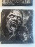 A square dark slate coaster featuring a highly detailed, high-contrast black and white relief carving of a horror character's screaming face, with a smaller profile view in the lower right.